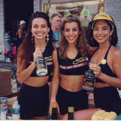 Three unknown woman at the Cristal Gold booth.