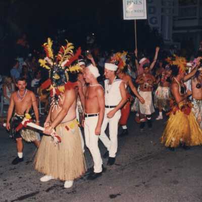 Unknown people dressed up walking in the parade.