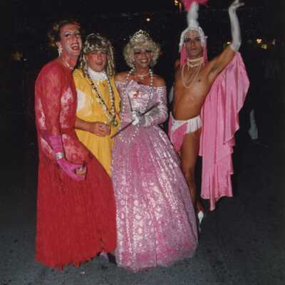 Four unknown people dressed up.