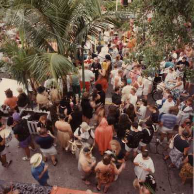 An Unknown group of people standing outside, some are dressed up in front of the Tropical Inn at 812 Duval Street.