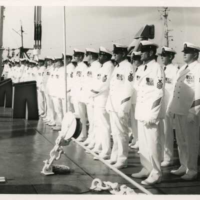 Unknown men in uniform on a ship standing at a ceremony