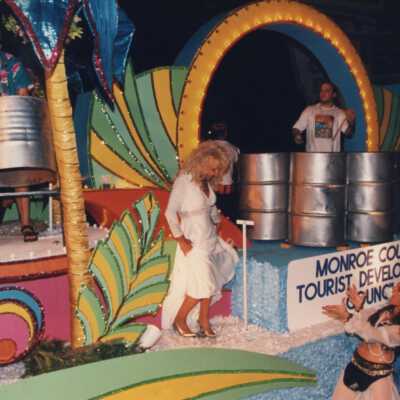 Unknown woman dressed up and holding a sign that says All Woman's dive club.
