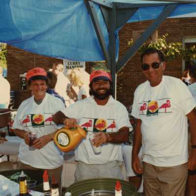 Three unknown people working a booth at the FF street fair.