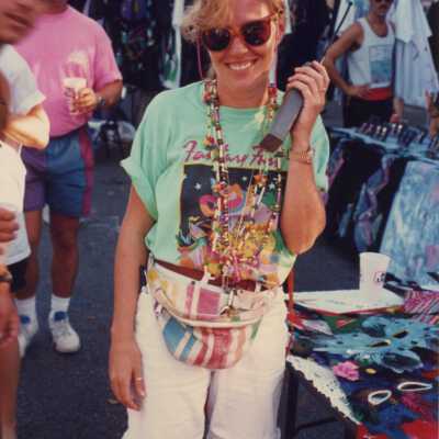 Unknown woman standing near a booth with a walkie-talkie.