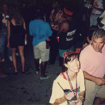 Rita Troxel walking with an unknown man and a group of people standing behind them.