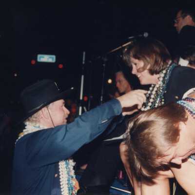 Unknown man handing beads out.