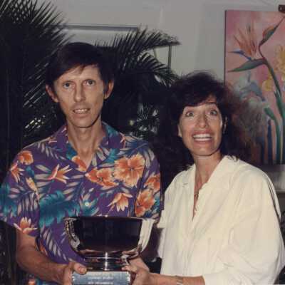Two unknown people accepting a trophy.