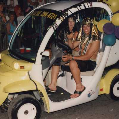 Unknown people in an egg electric car in the parade.