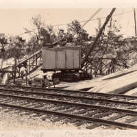 Crane, pilings, and railroad tracks