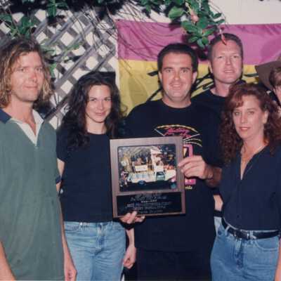 Unknown people accepting an award at the award ceremony.