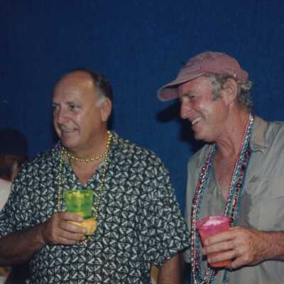 Two unknown men drinking and talking.