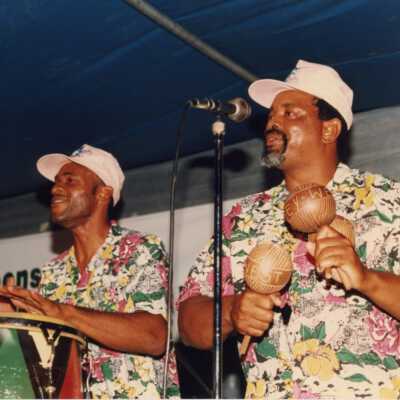 Two unknown men playing in a band at the Goombay celebration.