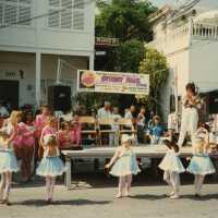 A group of unknown kids dancing in front of a stage.