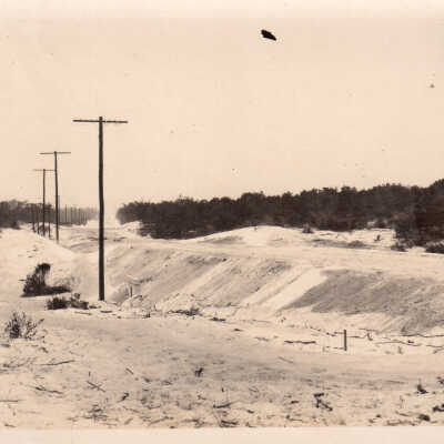 Sand dune and telephone poles