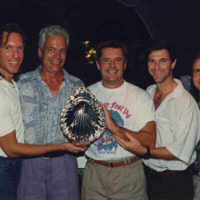Dennis Beaver with other unknown men holding an award at the awards ceremony.