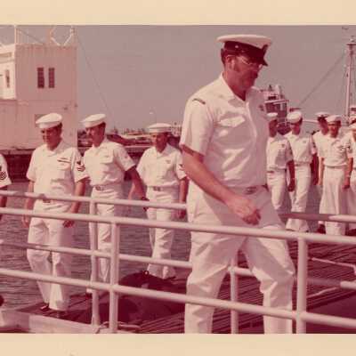 U.S. Navy men walking on a dock