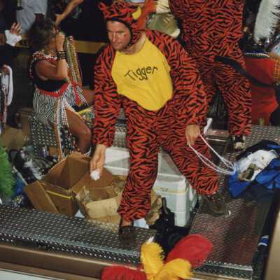 Unknown people dressed up on a float in the parade.