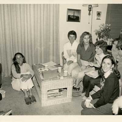 A group of unknown woman sitting in a living room