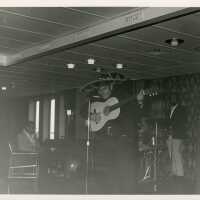 An unknown man singing in a band