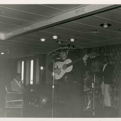 An unknown man singing in a band