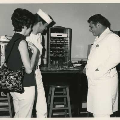 Unknown people looking at something on a table