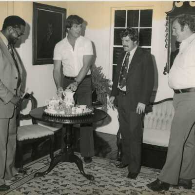4 Unknown men standing inside at a party