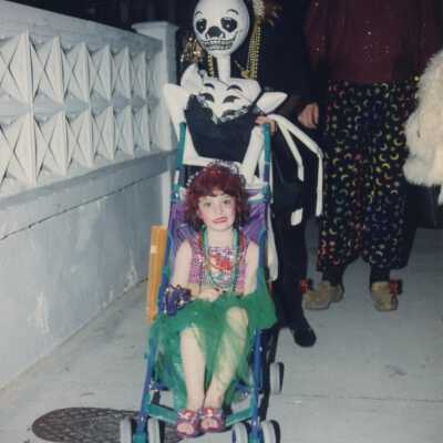 An unknown family dressed up walking.