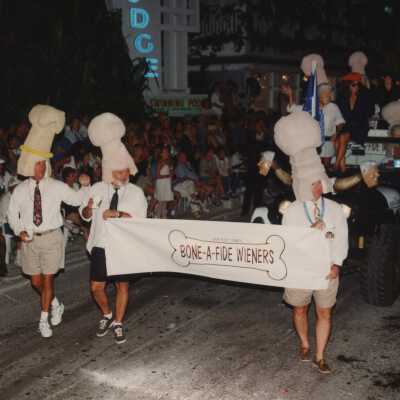 A float and banner in the parade, banner reads Bone a fide wieners.