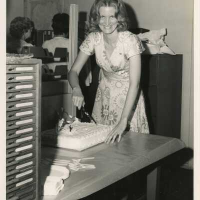 Margaret Carey is cutting her farewell cake