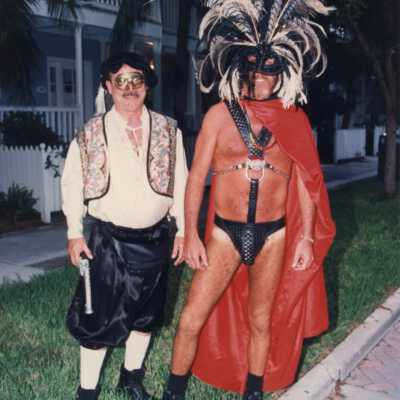Two unknown men dressed up.