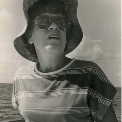 An unknown woman with an ocean view behind her