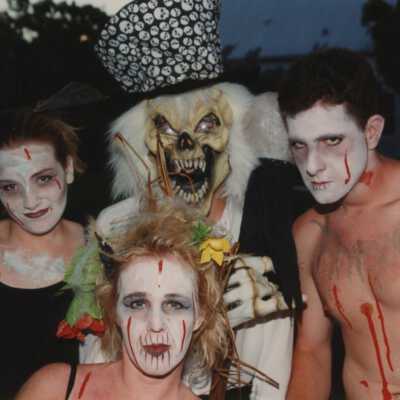 Four unknown people dressed up.