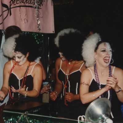 Unknown people dressed up on float in the parade.