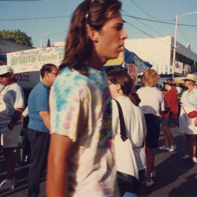 Unknown people walking in the street at the fair.