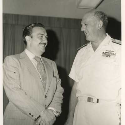 U.S. Navy man talking to an unknown man
