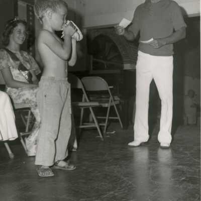 A child blowing a conch