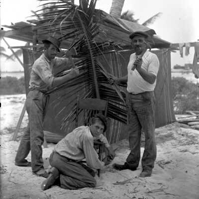Three Men Repairing a Chair