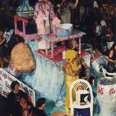 Unknown people dressed up on a float in the parade.