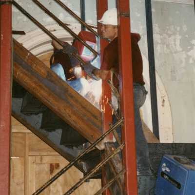 Dowling's welding install handrails at the North fire stairway.