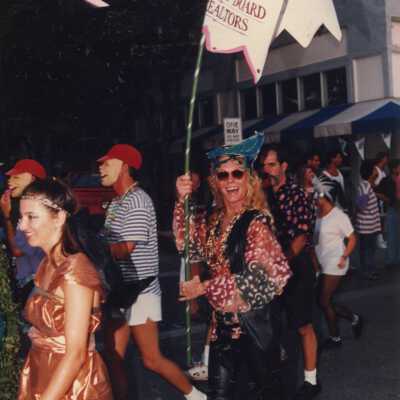 Unknown people dressed up walking in the street.