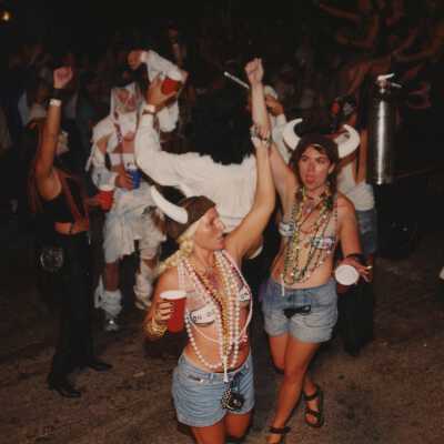 Unknown people dressed up walking in the street for the parade.