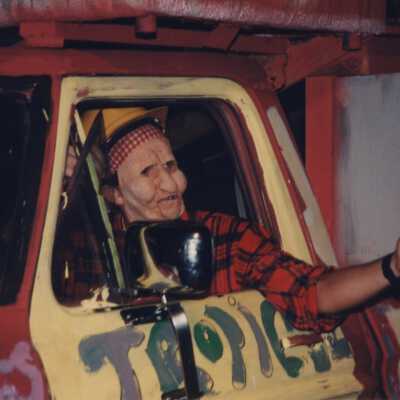 An unknown man dressed up driving one of the floats.