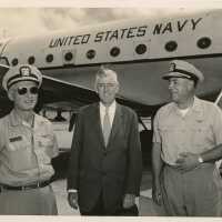 3 Men standing in front of a plane