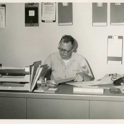 U.S. Navy man working at a desk in an office