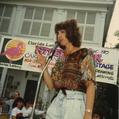 Unknown woman speaking on stage at the FF street fair.