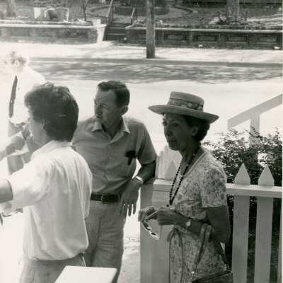 Unknown people standing outside of a house