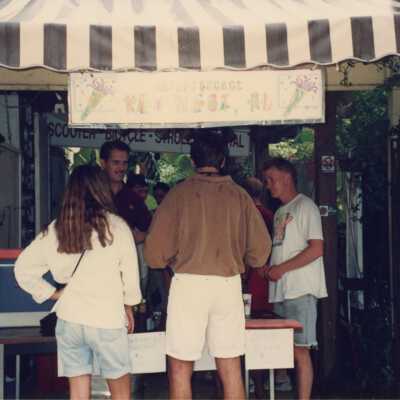Unknown people standing around talking to each other.