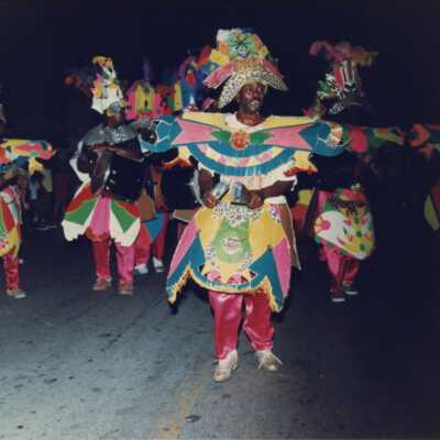 Unknown people dressed up in a band walking in the parade.