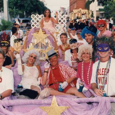 Unknown people dressed up on float.