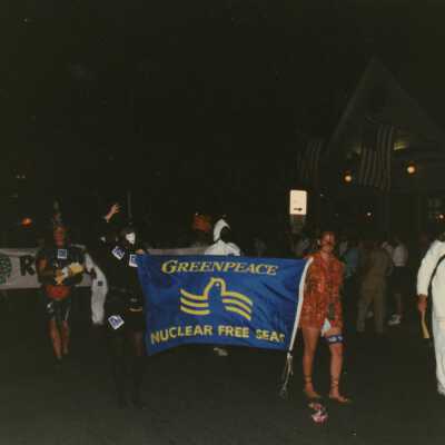 Unknown people dressed up walking in the street for the parade.